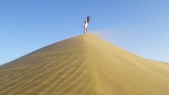 Landscape of girl on sand dune
