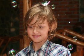 Portrait of a boy on a background of soap bubbles