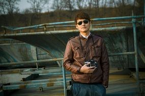 a young man in sunglasses and with a camera