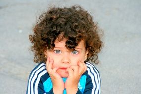 blue-eyed boy with curly hair