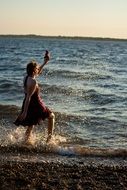 girl goes on water on the beach