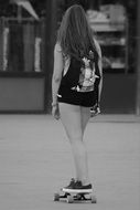 teen girl on skateboard in city