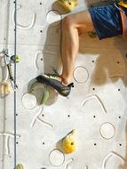 strong male leg man on climbing wall