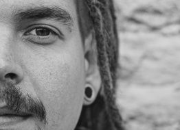 black and white portrait of a young man with dreadlocks