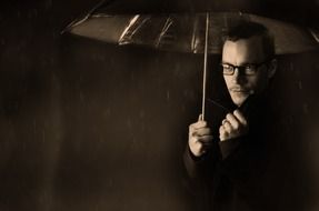 Monochrome picture of man is under the umbrella