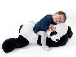 happy baby sitting on a panda