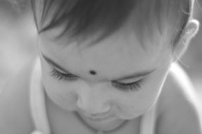 black and white photo of a little indian child
