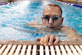 swimmer with the glasses in the water in the swimming pool