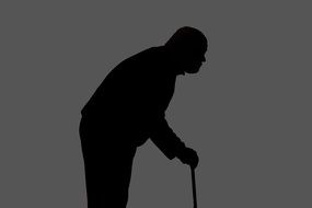 silhouette of an elderly man with a cane