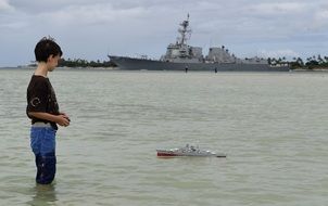 boy playing toy in water