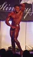 bodybuilder with red body on stage