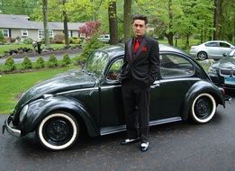 young man near a classic car