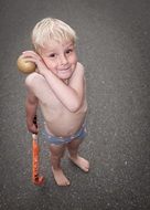 baby plays hockey in summer