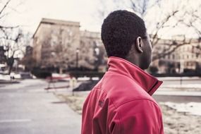 afroamerican teen walks down the street