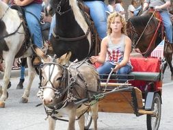 girl on a carriage on parade