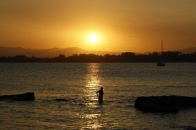 Human on a beach at the sunset