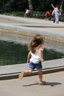 little girl runs along the track