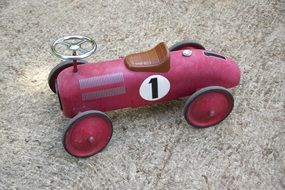 pink toy car on earth