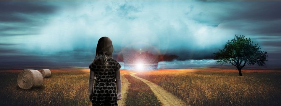 image of a girl in the countryside on the background of an atomic explosion