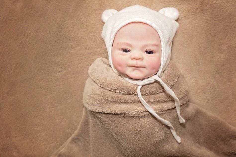 photo of baby in a white cap