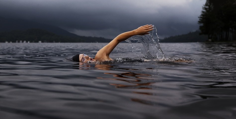 swimmer in dark lake
