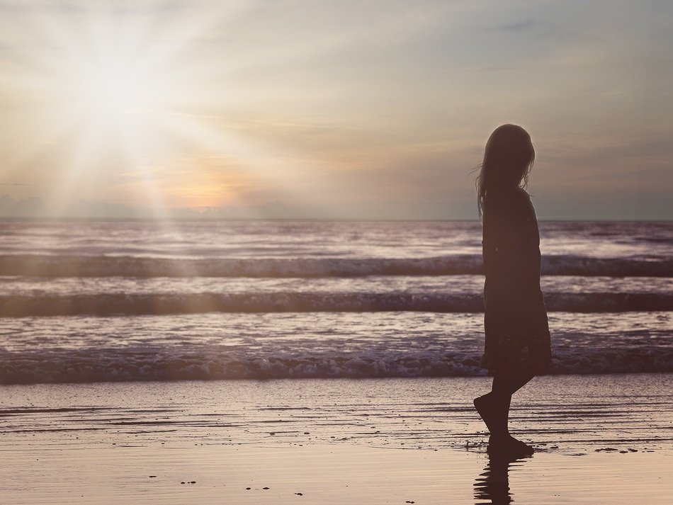 female silhouette on the ocean beach