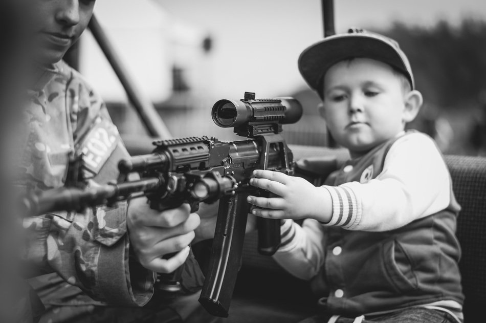 Portrait of young child and weapon