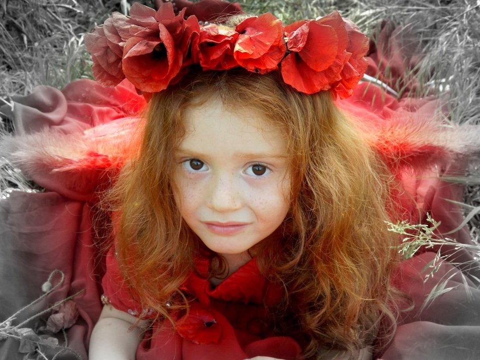girl in a red dress and with a wreath of red flowers