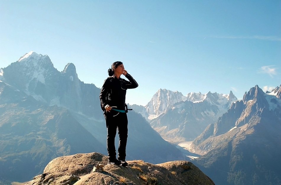 man standing on top of mountain