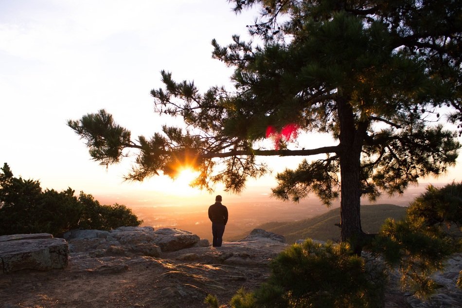 Photo of standing male at the mountain
