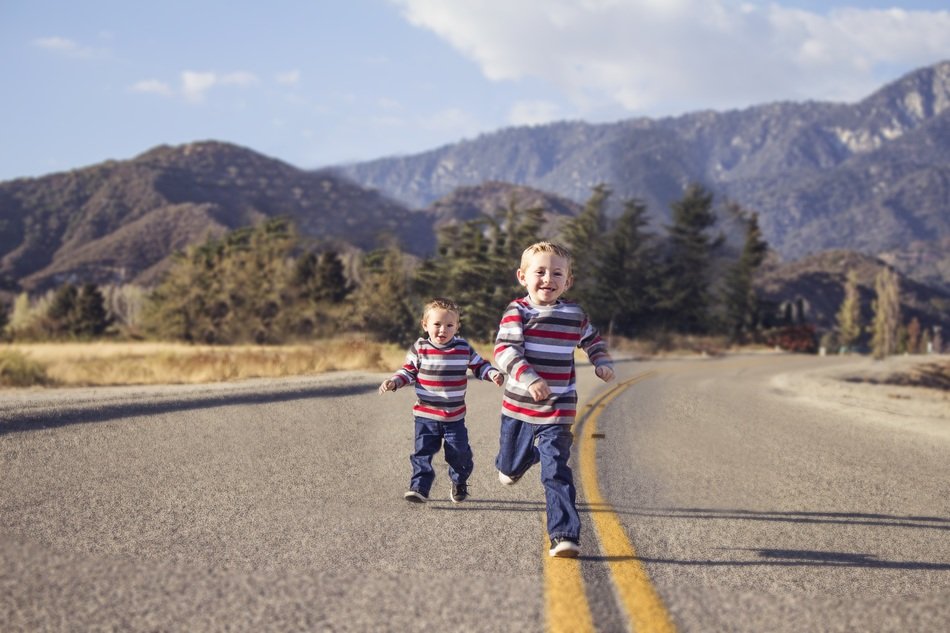 Photo of running brothers on a road