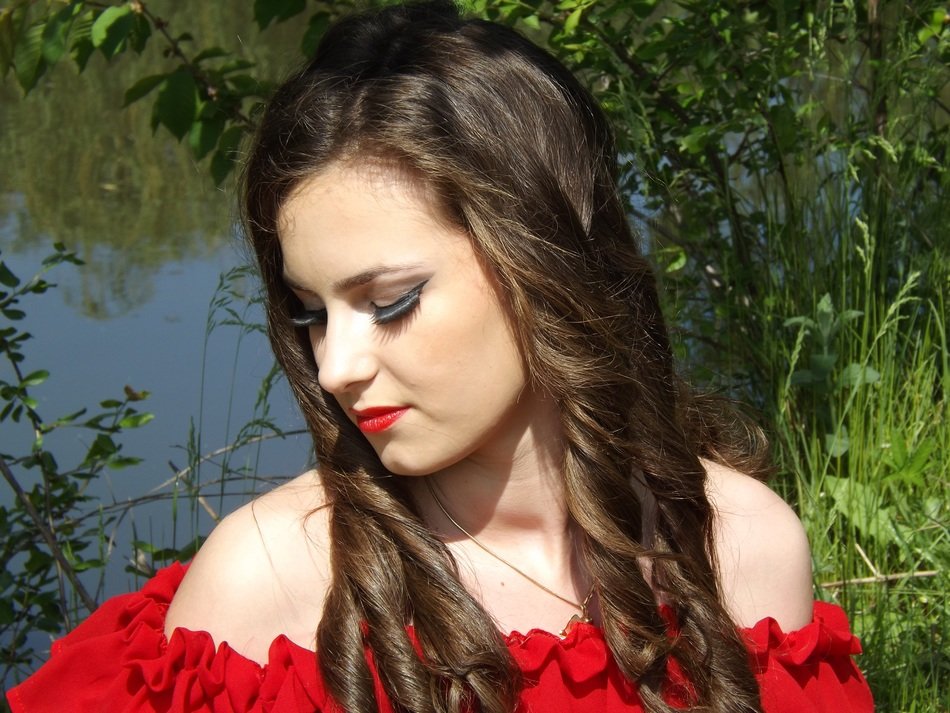 portrait of a beauty in a red dress and red lips