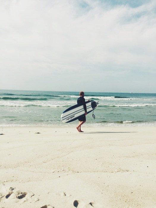 surfer on the incredibly beautiful beach