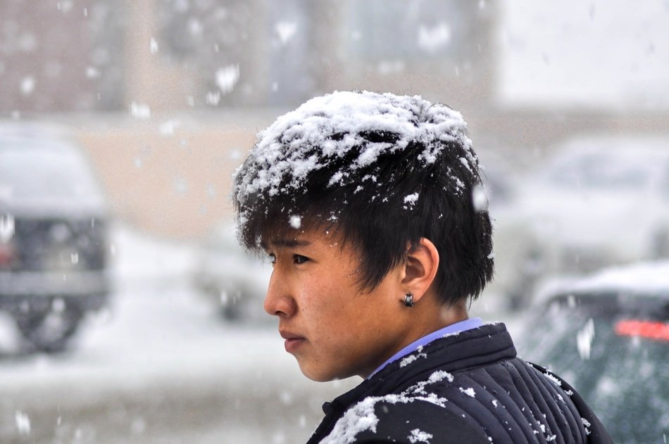 A man on the street during heavy snow