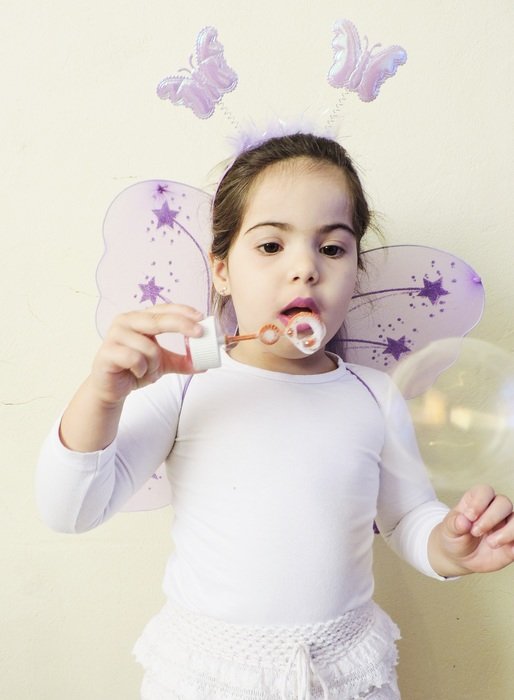 girl playing with soap bubble