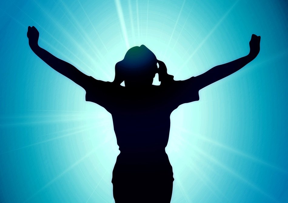 silhouette of a happy woman on a background of sun shine