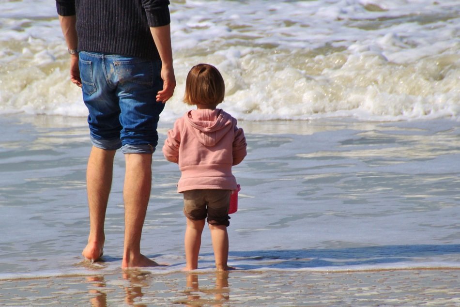 child girl and man at the sea