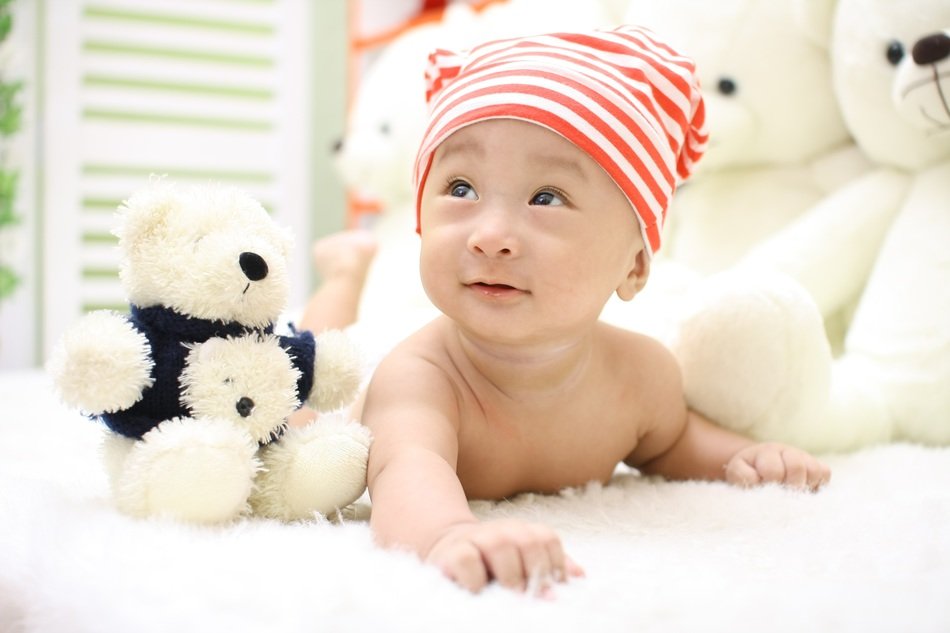 happy baby on the background of teddy bears