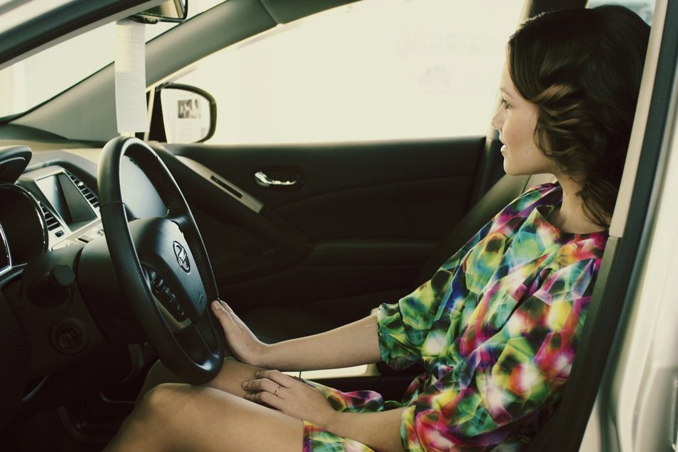 beautiful girl sits in car