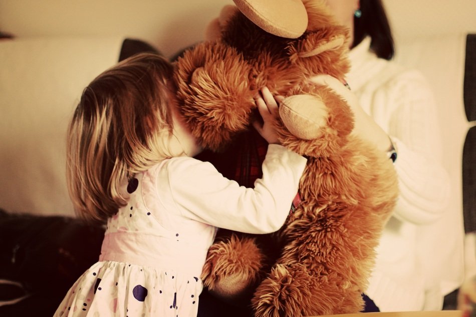 little girl near a teddy bear