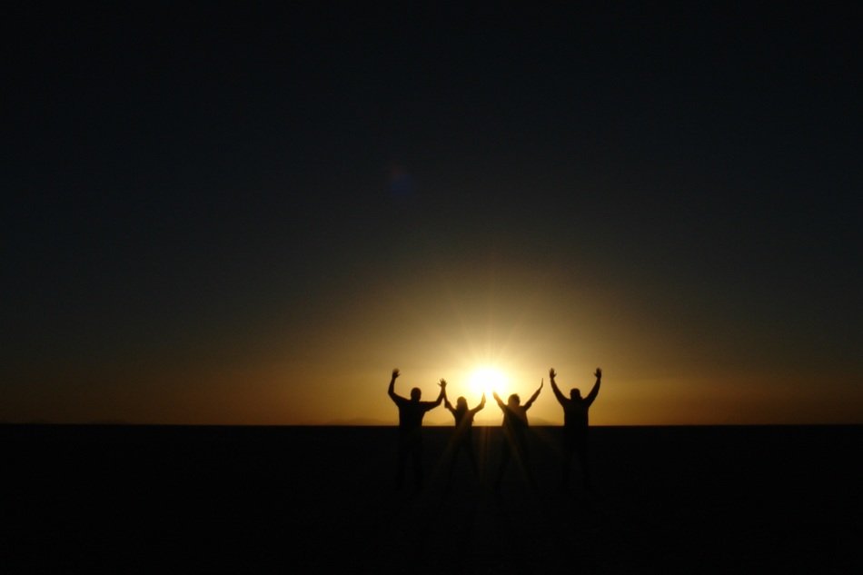 People at the background of the setting sun