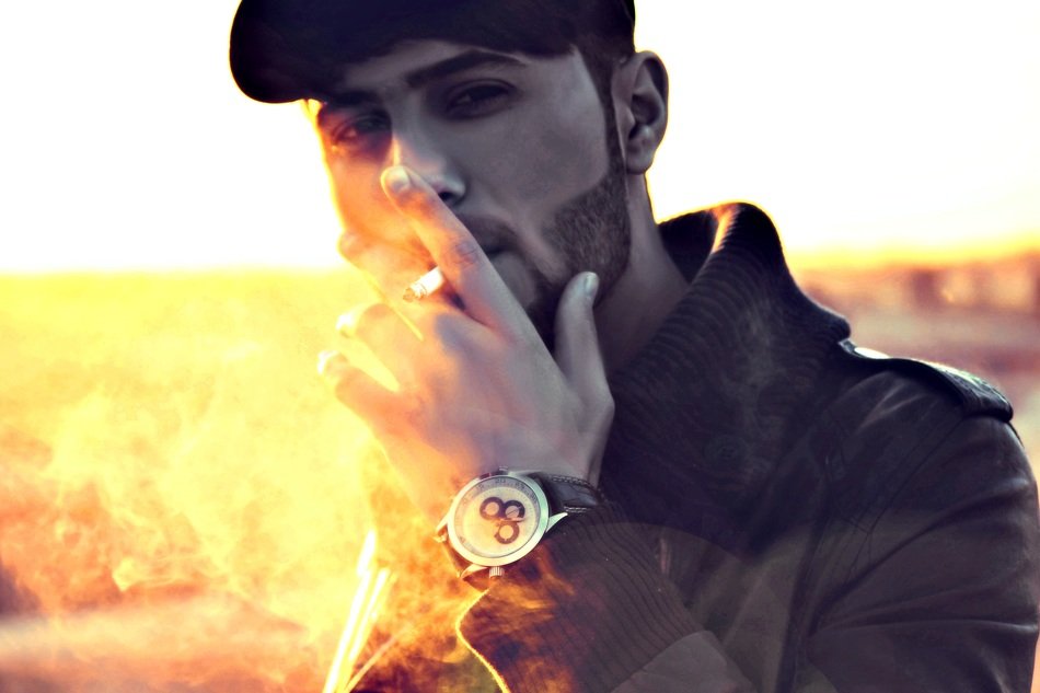 Man smoking cigarette at background with the light in Iraq