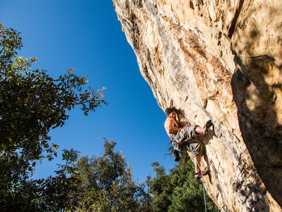 a man with a muscular body on a rock