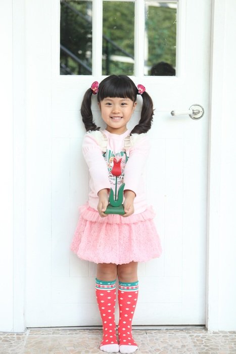 happy little girl near the wall