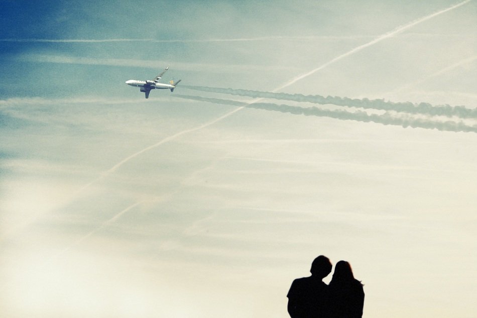 aircraft and silhouette of couple at blue sky