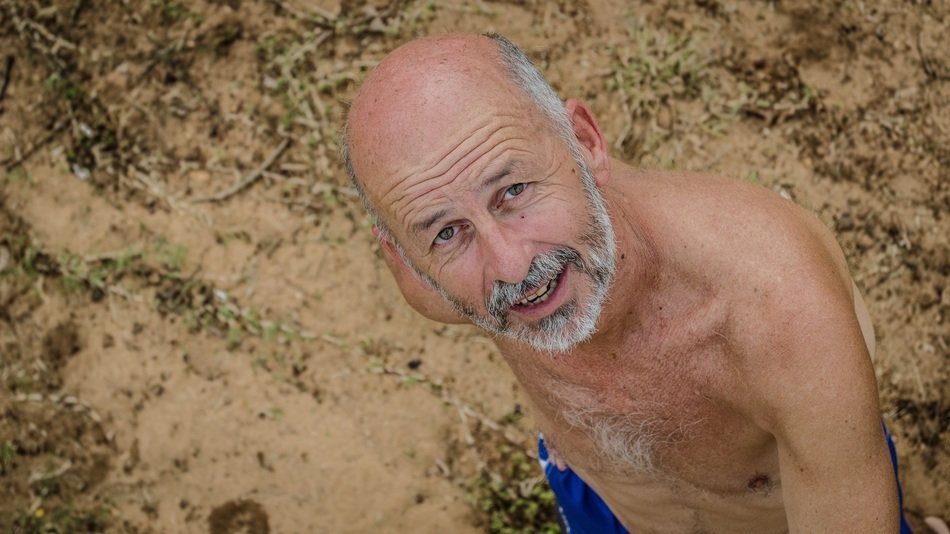 man with a gray beard on the beach