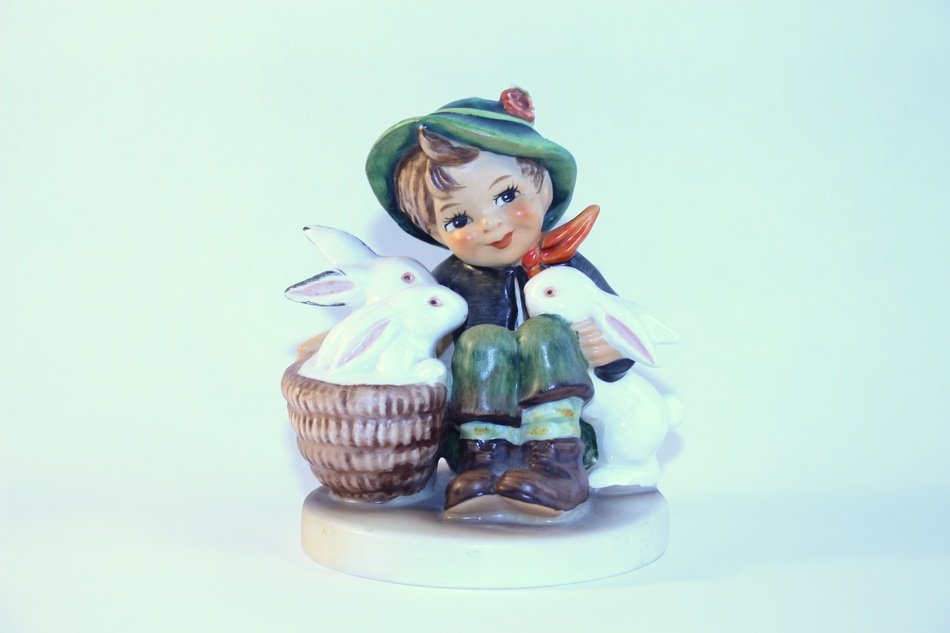 porcelain figure of a boy with rabbits