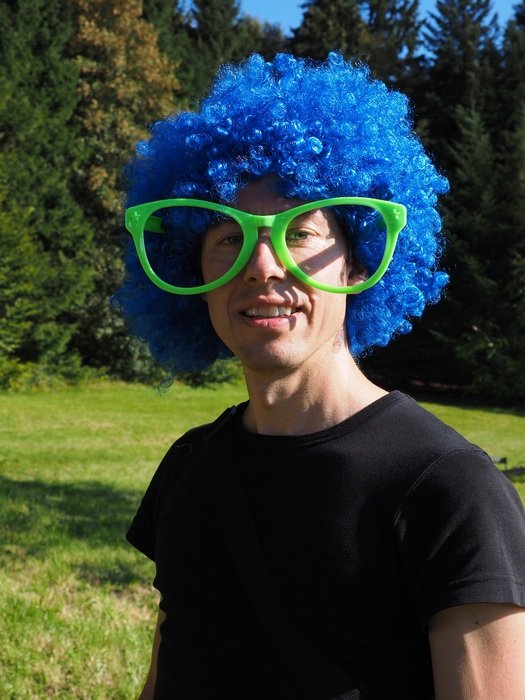 man in blue carnival wig outdoor, atze schrÃ¶der parody