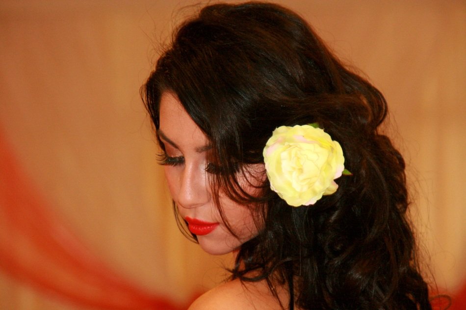 brunette with a white rose in her hair