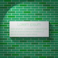Green brick wall with banner
